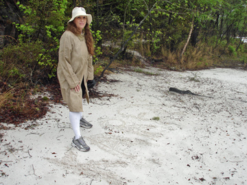 Karen Duquette at the beach in her rain gear