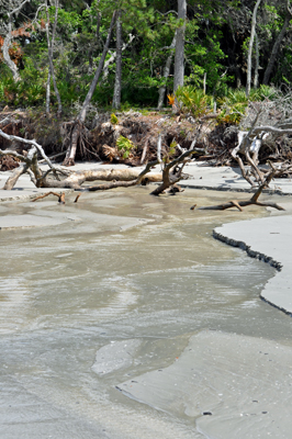 The ocean makes a water path in the sand