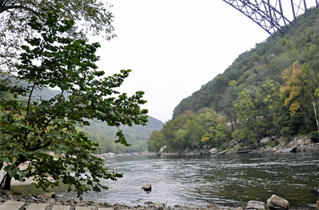 View of the New River Gorge Bridge and the catwalk from the boat ramp 