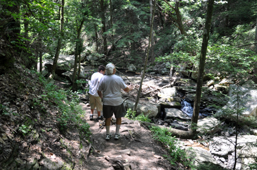 The two RV Gypsies and their grandson are approaching the first waterfall