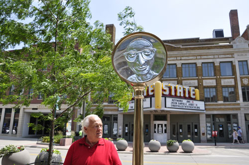 Lee Duquette at the Look Closer sculpture - a magnifying glass