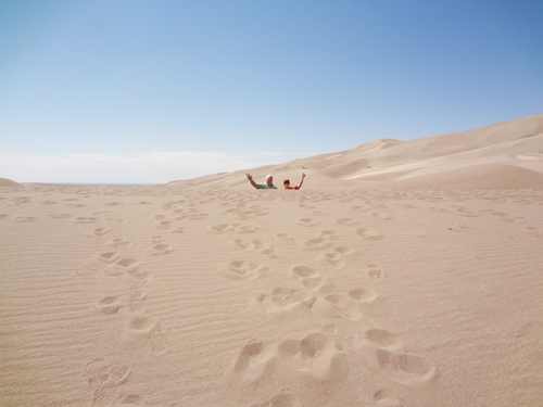 The two RV Gypsies in-between two large sand dunes.