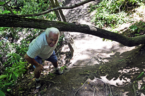 Lee Duquette ducking under a tree branch