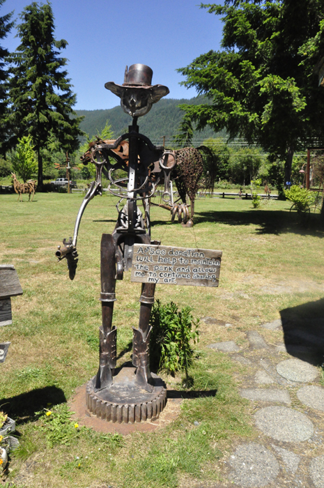 donation request sculpture with sign asking for donations