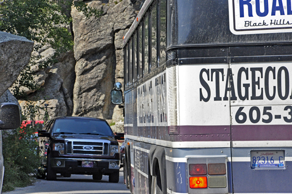 tour bus trying to get through the road