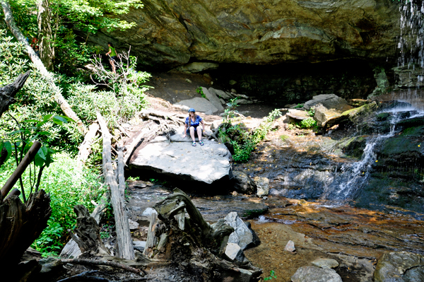 Karen Duquette slides down the boulder