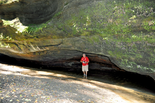 Lee Duquette under the ledge of a cliff