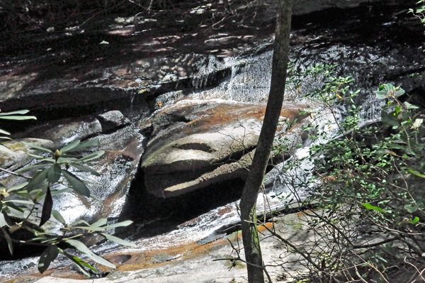 water flowing over a boulder