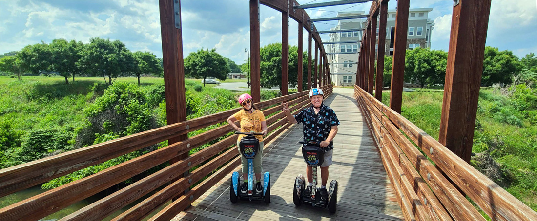 The two RV Gypsies on their Segvways on a bridge
