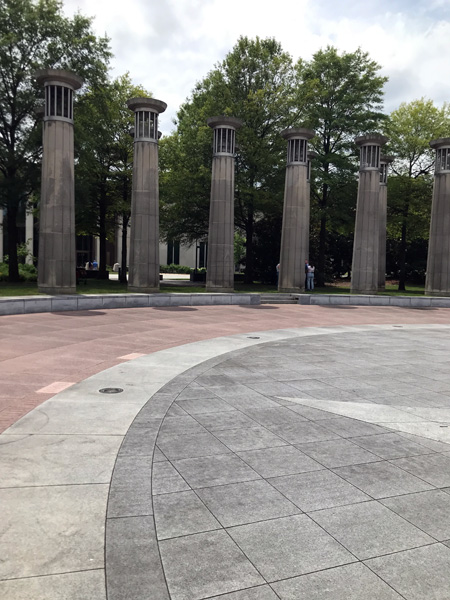 vertical pylons with engraved images from war time