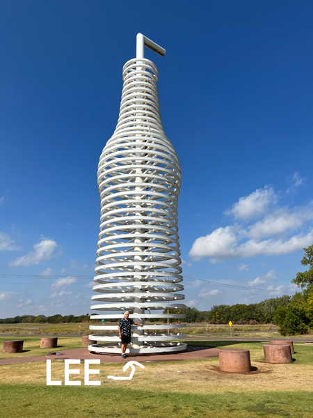 a large soda bottle and straw amd Lee Duquette