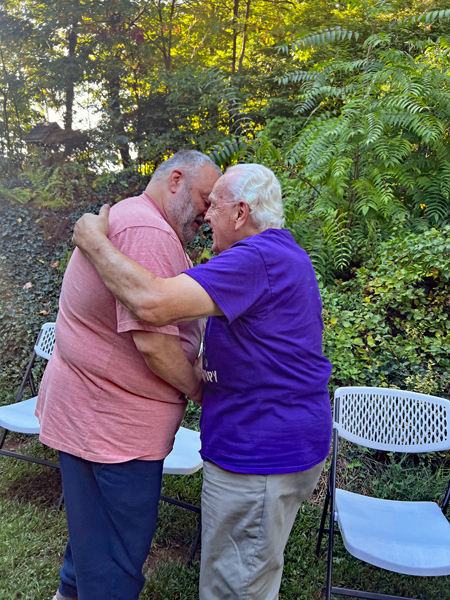 Gary and Lee Duquette hug