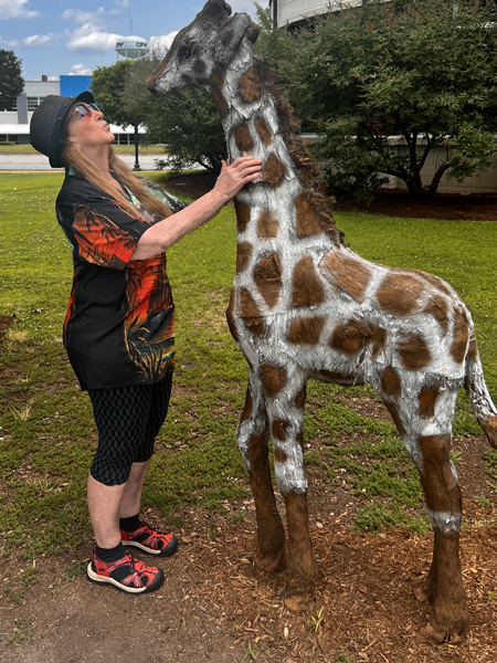 Karen Duquette gave the baby giraffe a loving kiss