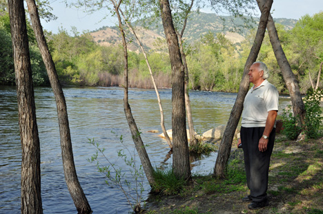 Lee on the beach enjoying a view of the river & the mountain 