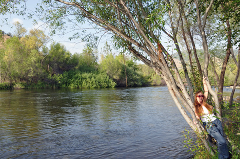 Karen on the beach enjoying a view of the river & the mountain 