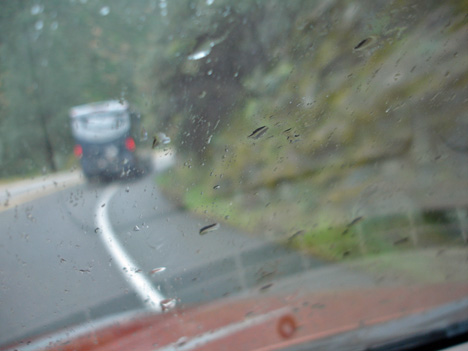 tight corners on a curvy narrow mountain road in the rain